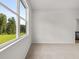 Light-filled bedroom with neutral carpet and view to green lawn through window at 408 Oak View Ln, Dallas, GA 30157