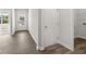 Neutral hallway with wood-look floors leading to the laundry room and an exterior door for convenience at 408 Oak View Ln, Dallas, GA 30157