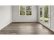 Bright living room with wood-style flooring, a window, and access to a patio at 408 Oak View Ln, Dallas, GA 30157
