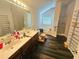 Bright bathroom featuring a dual sink vanity, soaking tub, and separate glass-enclosed shower at 4925 Locherby Dr, Fairburn, GA 30213