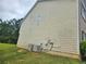 Side exterior of home, featuring green grass and residential landscape at 4925 Locherby Dr, Fairburn, GA 30213