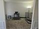 Living room with workspace, neutral walls, and a pet crate at 4925 Locherby Dr, Fairburn, GA 30213
