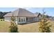 Rear exterior showcasing a spacious backyard and covered patio at 1609 Tielman Way, Snellville, GA 30078