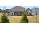 Exterior view of backyard and covered patio with lawn and landscaping at 1609 Tielman Way, Snellville, GA 30078