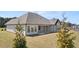 Backyard with covered porch and well-maintained lawn and landscaping at 1609 Tielman Way, Snellville, GA 30078