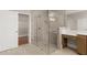 Modern bathroom featuring a glass shower and vanity area with plenty of natural light at 1609 Tielman Way, Snellville, GA 30078