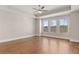 Bedroom with hardwood floors, ceiling fan and three large windows with scenic views at 1609 Tielman Way, Snellville, GA 30078