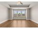 Spacious bedroom showcasing hardwood floors, three large windows, and plenty of natural light at 1609 Tielman Way, Snellville, GA 30078