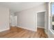 Bright bedroom featuring hardwood floors, neutral paint, and walk-in closet at 1609 Tielman Way, Snellville, GA 30078
