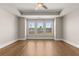 Bedroom with hardwood floors, ceiling fan and three large windows with scenic views at 1609 Tielman Way, Snellville, GA 30078