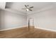 Bright bedroom features hardwood floors, a tray ceiling, and neutral paint at 1609 Tielman Way, Snellville, GA 30078