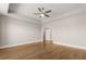 Bedroom with hardwood floors, ceiling fan, tray ceiling and a door to the closet at 1609 Tielman Way, Snellville, GA 30078