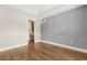 Elegant dining room with decorative wall paneling, modern chandelier and hardwood floors at 1609 Tielman Way, Snellville, GA 30078
