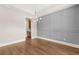Bright dining room featuring hardwood floors, decorative wall paneling, and modern lighting at 1609 Tielman Way, Snellville, GA 30078