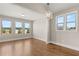 Bright dining room with hardwood floors, large windows, and elegant lighting for a welcoming atmosphere at 1609 Tielman Way, Snellville, GA 30078