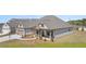 Beautiful new construction home with a three-car garage and manicured lawn at 1609 Tielman Way, Snellville, GA 30078