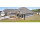 A beautiful single Gathering home with manicured lawn, a two car garage, and stone-accented porch columns at 1609 Tielman Way, Snellville, GA 30078