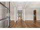 Elegant foyer featuring hardwood floors, neutral walls, and a view into the living spaces at 1609 Tielman Way, Snellville, GA 30078