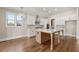 Spacious kitchen with an island, stainless steel appliances, modern finishes, and hardwood floors at 1609 Tielman Way, Snellville, GA 30078