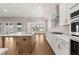 Modern kitchen with a large island, stainless steel appliances, and stylish finishes for a seamless cooking experience at 1609 Tielman Way, Snellville, GA 30078