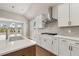 Bright kitchen features white cabinets, quartz countertops, stainless steel appliances, and a view of the backyard at 1609 Tielman Way, Snellville, GA 30078