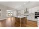 Bright kitchen features stainless appliances, a view to the backyard, white countertops and a kitchen island at 1609 Tielman Way, Snellville, GA 30078