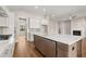Open kitchen with a large island, stainless steel appliances, and modern fixtures; ideal for entertaining at 1609 Tielman Way, Snellville, GA 30078