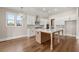 Bright, open kitchen with a large island, stylish lighting, and modern appliances; perfect for cooking and gatherings at 1609 Tielman Way, Snellville, GA 30078