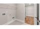 Laundry room features tile floors, a door to the walk-in closet, and modern appliances at 1609 Tielman Way, Snellville, GA 30078