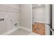Well-organized laundry room featuring tile flooring, wire shelving, and convenient utility connections at 1609 Tielman Way, Snellville, GA 30078