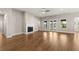 Open living room featuring hardwood floors, fireplace, ceiling fan and backyard access at 1609 Tielman Way, Snellville, GA 30078