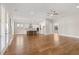 Spacious open-concept living area connects to a modern kitchen with hardwood floors and lots of natural light at 1609 Tielman Way, Snellville, GA 30078