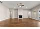 Spacious living room featuring hardwood floors, a cozy fireplace, and ample natural light at 1609 Tielman Way, Snellville, GA 30078