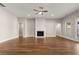 Spacious living room featuring a fireplace and modern ceiling fan at 1609 Tielman Way, Snellville, GA 30078