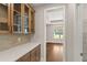 Well-organized pantry featuring ample cabinet space, quartz countertops and open shelving for convenient storage at 1609 Tielman Way, Snellville, GA 30078