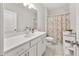 Bright bathroom with a large vanity, a shower-tub, and neutral walls at 3 Hundley Ln, Roswell, GA 30076