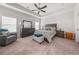 A cozy bedroom featuring a tray ceiling, ceiling fan, and coordinating furniture at 3 Hundley Ln, Roswell, GA 30076