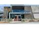 The sleek and modern Topgolf building featuring glass entry doors and landscaped surroundings at 3 Hundley Ln, Roswell, GA 30076