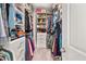 A well-organized walk-in closet featuring hanging rods, shelving, and drawer units for storage at 3 Hundley Ln, Roswell, GA 30076