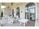 The covered porch features rocking chairs, a table, and comfortable seating, creating a relaxing outdoor space at 3 Hundley Ln, Roswell, GA 30076