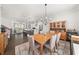 A spacious dining area open to the living room and kitchen with modern light fixtures at 3 Hundley Ln, Roswell, GA 30076