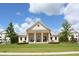 Harlow Hall showcases beautiful architecture, with a well-maintained lawn and vibrant floral arrangements at 3 Hundley Ln, Roswell, GA 30076