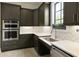 A modern kitchen boasts sleek gray cabinets, stainless steel appliances, and chic backsplash at 3 Hundley Ln, Roswell, GA 30076