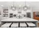 Bright kitchen features an oversized island with seating and stylish pendant lighting at 3 Hundley Ln, Roswell, GA 30076