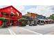 Vibrant street view showcasing Mac McGee's red building with a charming balcony and other local shops at 3 Hundley Ln, Roswell, GA 30076
