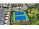Aerial view of two well-maintained tennis courts in a residential community, surrounded by green landscaping at 3 Hundley Ln, Roswell, GA 30076
