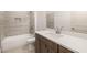 Modern bathroom with gray tiled walls, a shower, and a vanity with a white countertop at 3772 Tielman St, Snellville, GA 30078