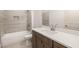 Modern bathroom boasts stylish gray tiles, a white vanity with countertop, and combined tub-shower combo at 3772 Tielman St, Snellville, GA 30078