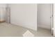 Bright bedroom featuring neutral carpet, fresh white walls, and doorway providing an airy, comfortable space at 3772 Tielman St, Snellville, GA 30078