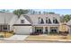 Charming single-Gathering home featuring a symmetrical facade, inviting front porch, and well-manicured front yard at 3772 Tielman St, Snellville, GA 30078